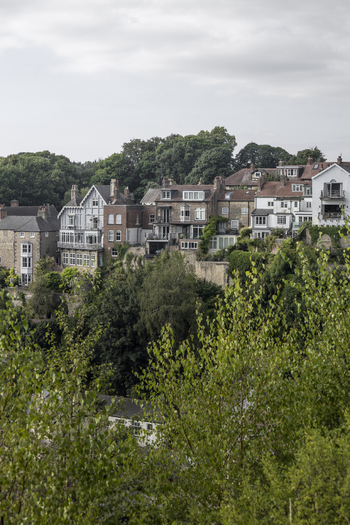 View of historic buildings perched on the cliffside in Knaresborough England United Kingdom.