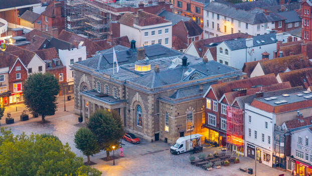 Aerial view of the historic Guildhall in Salisbury surrounded by traditional brick buildings market square and urban streets in Salisbury England United Kingdom. Aerial view of the historic Guildhall in Salisbury surrounded by traditional brick buildings market square and urban streets in Salisbury England United Kingdom.