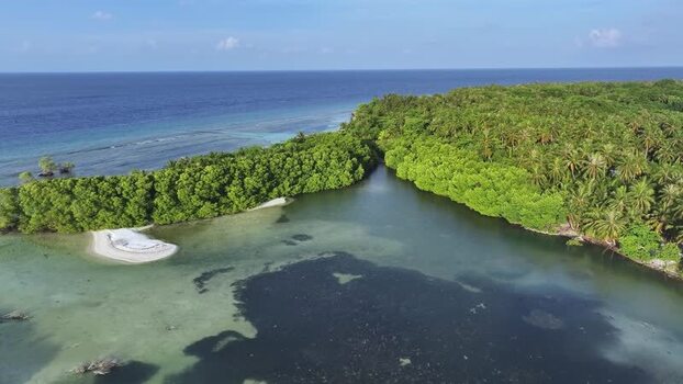 Aerial view of a lush tropical island and turquoise lagoon Maldives. Aerial view of a lush tropical island and turquoise lagoon Maldives.