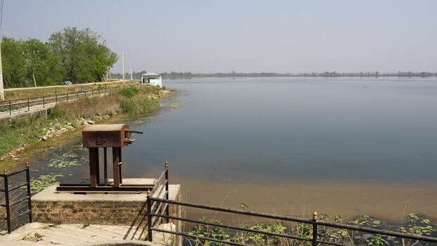 View of a calm lake with a water control gate Nepal.