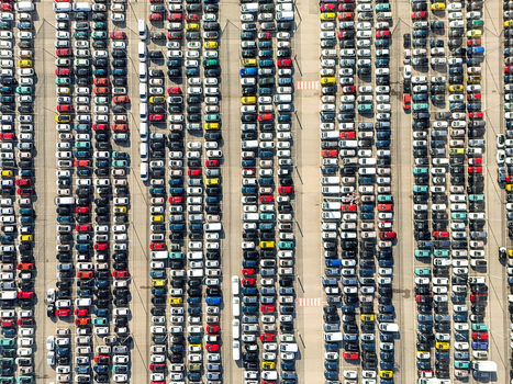 Aerial view of thousands of colorful new cars parked in neat vertical rows at a large automotive logistics hub in Rivalta di Torino Piedmont Italy. Aerial view of thousands of colorful new cars parked in neat vertical rows at a large automotive logistics hub in Rivalta di Torino Piedmont Italy.