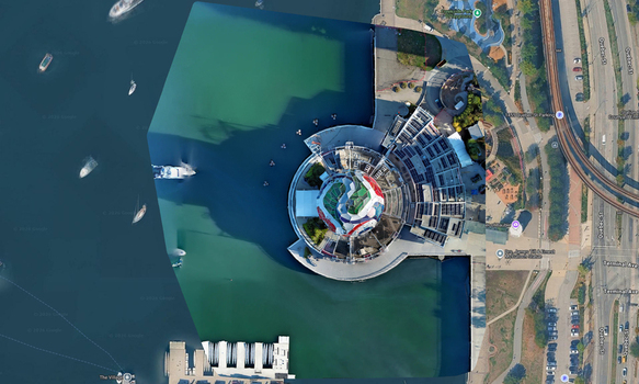 Aerial view of Science World building with its iconic geodesic dome situated on the waterfront surrounded by urban infrastructure and parkland in Vancouver British Columbia Canada. Aerial view of Science World building with its iconic geodesic dome situated on the waterfront surrounded by urban infrastructure and parkland in Vancouver British Columbia Canada.