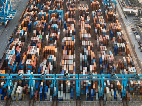 Aerial view of the semi automated container port with rows of colorful shipping containers and automated gantry cranes in Vado Ligure Liguria Italy. Aerial view of the semi automated container port with rows of colorful shipping containers and automated gantry cranes in Vado Ligure Liguria Italy.