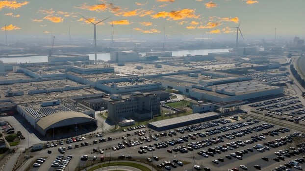 Aerial view of Auto Industriale Bergamasca S.p.A. industrial complex with large factory buildings extensive parking lots and wind turbines in Dalmine Lombardia Italy. Aerial view of Auto Industriale Bergamasca S.p.A. industrial complex with large factory buildings extensive parking lots and wind turbines in Dalmine Lombardia Italy.