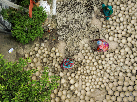 Joypurhat Rajshahi Division Bangladesh 28 September 2026 Aerial view of women in colorful saris working with hundreds of unglazed clay bowls drying on the ground. Joypurhat Rajshahi Division Bangladesh 28 September 2026 Aerial view of women in colorful saris working with hundreds of unglazed clay bowls drying on the ground.