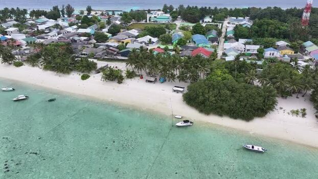 Aerial view of a tropical island village and beach Maldives. Aerial view of a tropical island village and beach Maldives.