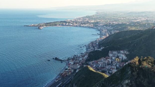 Aerial view of the coastline and hills in Taormina Italy.