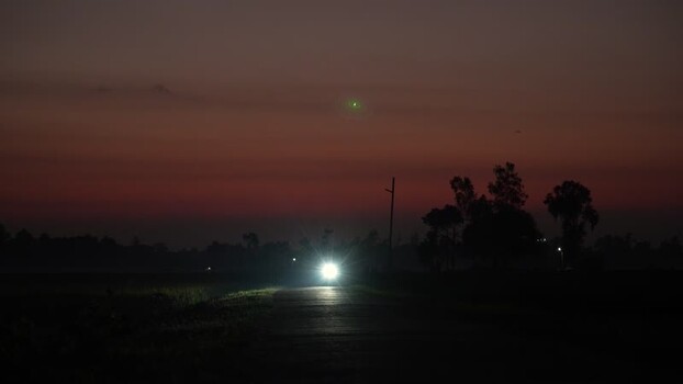 View of a vehicle headlight on a dark rural road Bangladesh. View of a vehicle headlight on a dark rural road Bangladesh.