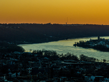 Aerial view of the river reflecting the golden sky between the dark silhouette of the land Parkersburg West Virginia United States. Aerial view of the river reflecting the golden sky between the dark silhouette of the land Parkersburg West Virginia United States.