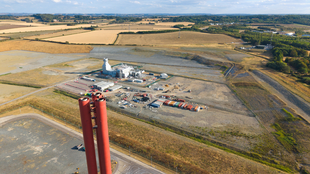 Aerial view of Millbrook Power Plant with its prominent red chimneys industrial facilities and surrounding rural landscape in Stewartby England United Kingdom. Aerial view of Millbrook Power Plant with its prominent red chimneys industrial facilities and surrounding rural landscape in Stewartby England United Kingdom.
