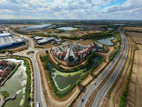 Aerial view of Wixams Retirement Village with its unique architecture surrounded by ponds roads and green fields in Bedford England United Kingdom.