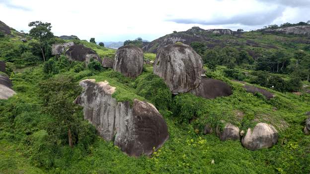 Aerial view of Idanre Hill with massive granite boulders and lush green vegetation in Idanre Ondo State Nigeria. Aerial view of Idanre Hill with massive granite boulders and lush green vegetation in Idanre Ondo State Nigeria.