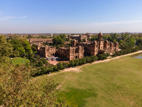 Aerial view of Islamia College University Peshawar with historic red brick buildings green lawns and trees under a clear sky in Peshawar Khyber Pakhtunkhwa Pakistan. Aerial view of Islamia College University Peshawar with historic red brick buildings green lawns and trees under a clear sky in Peshawar Khyber Pakhtunkhwa Pakistan.