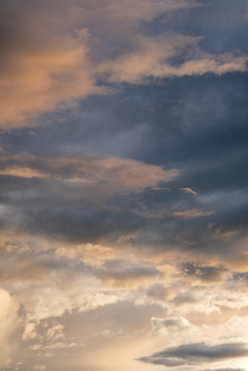 View of dramatic storm clouds at sunset over the Sacred Valley with golden light illuminating the dark sky in Urubamba Province Cusco Peru. View of dramatic storm clouds at sunset over the Sacred Valley with golden light illuminating the dark sky in Urubamba Province Cusco Peru.