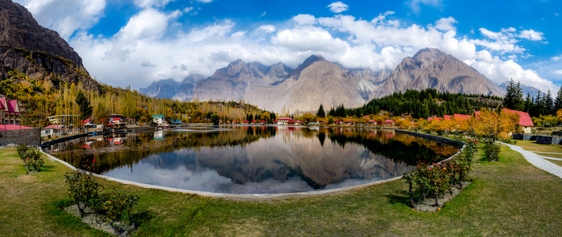 View of Shangrila Resort Skardu situated on the shores of a calm lake surrounded by vibrant autumn trees and towering mountains in Skardu Gilgit Baltistan Pakistan. View of Shangrila Resort Skardu situated on the shores of a calm lake surrounded by vibrant autumn trees and towering mountains in Skardu Gilgit Baltistan Pakistan.