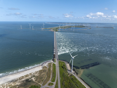 Aerial view of the Eastern Scheldt Storm Surge Barrier with wind turbines and coastal landscape in Vrouwenpolder Zeeland Netherlands. Aerial view of the Eastern Scheldt Storm Surge Barrier with wind turbines and coastal landscape in Vrouwenpolder Zeeland Netherlands.
