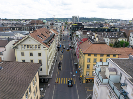Aerial view of a city street lined with historic buildings and rooftops under a cloudy sky in Biel Bienne Canton of Bern Switzerland. Aerial view of a city street lined with historic buildings and rooftops under a cloudy sky in Biel Bienne Canton of Bern Switzerland.