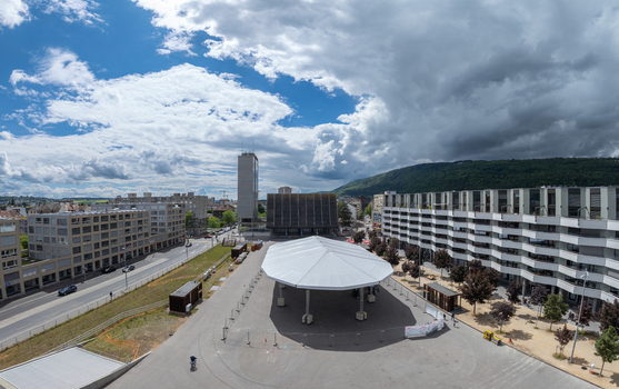 Aerial view of Esplanade Kongresshaus 11 with its large white canopy surrounded by modern buildings and forested hills in Biel Bienne Canton of Bern Switzerland. Aerial view of Esplanade Kongresshaus 11 with its large white canopy surrounded by modern buildings and forested hills in Biel Bienne Canton of Bern Switzerland.