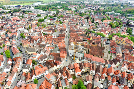 Aerial view of the Rathaus Forchheim and the historic old town with its traditional red tiled roofs and the St. Martin church tower in Forchheim Bayern Germany.