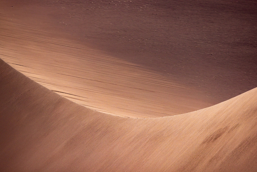 View of the smooth curves and wind swept textures of the sand dunes in the Valley of the Moon San Pedro de Atacama Antofagasta Chile. View of the smooth curves and wind swept textures of the sand dunes in the Valley of the Moon San Pedro de Atacama Antofagasta Chile.