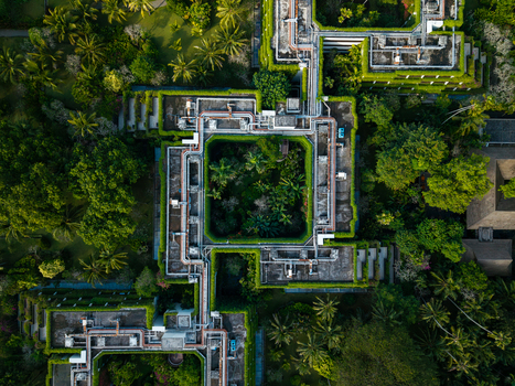 Aerial view of a modern building with lush green rooftop gardens and tropical vegetation in Kecamatan Denpasar Selatan Bali Indonesia. Aerial view of a modern building with lush green rooftop gardens and tropical vegetation in Kecamatan Denpasar Selatan Bali Indonesia.