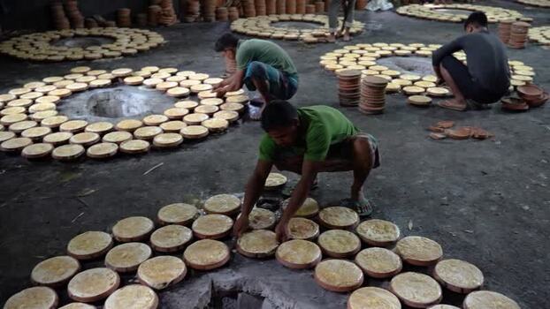 View of workers arranging clay pots in Bogura Bangladesh. View of workers arranging clay pots in Bogura Bangladesh.