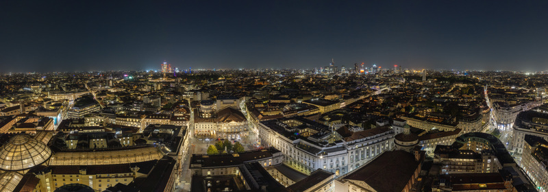 Milan Italy 23 September 2026 Aerial view of the illuminated cityscape of Milan at night featuring historic architecture glowing streetlights and the modern skyline. Milan Italy 23 September 2026 Aerial view of the illuminated cityscape of Milan at night featuring historic architecture glowing streetlights and the modern skyline.
