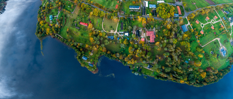 Aerial view of Araisi Windmill surrounded by lush green fields autumn trees and a calm lake in Drabesu pagasts Cesu novads Latvia. Aerial view of Araisi Windmill surrounded by lush green fields autumn trees and a calm lake in Drabesu pagasts Cesu novads Latvia.
