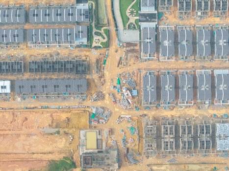 Aerial view of construction housing project with rows of new residential buildings unfinished structures and earthworks in Bukit Mertajam Penang Malaysia. Aerial view of construction housing project with rows of new residential buildings unfinished structures and earthworks in Bukit Mertajam Penang Malaysia.