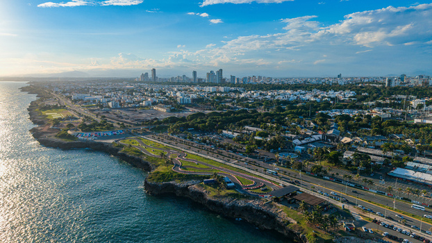 Aerial view of Feria Ganadera along the coastline with a go kart track lush green spaces and the urban skyline of Santo Domingo Distrito Nacional Dominican Republic. Aerial view of Feria Ganadera along the coastline with a go kart track lush green spaces and the urban skyline of Santo Domingo Distrito Nacional Dominican Republic.