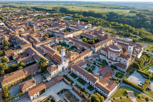 Aerial view of the historic town center of Cherasco featuring red tiled rooftops the San Pietro church dome and the Belvedere arch in Cherasco Piedmont Italy. Aerial view of the historic town center of Cherasco featuring red tiled rooftops the San Pietro church dome and the Belvedere arch in Cherasco Piedmont Italy.