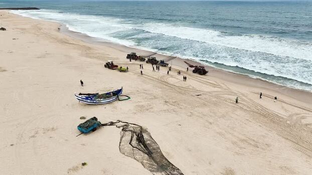 Aerial view of fishermen and boats on the beach Portugal. Aerial view of fishermen and boats on the beach Portugal.