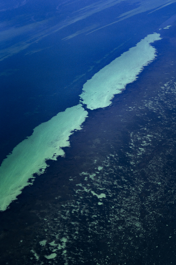 Aerial view of turquoise ocean patterns and coral reefs in the shallow waters of the Indian Ocean in Shire of Shark Bay Western Australia Australia. Aerial view of turquoise ocean patterns and coral reefs in the shallow waters of the Indian Ocean in Shire of Shark Bay Western Australia Australia.