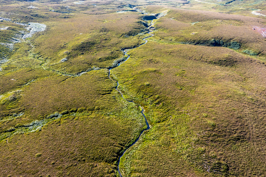 Aerial view of the rugged moorland landscape and winding stream at An Port near Ardara County Donegal Ireland.