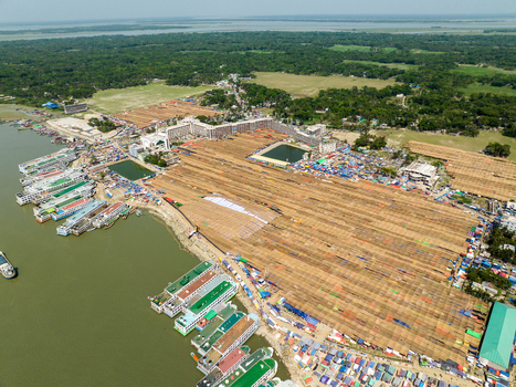 Aerial view of the vast landscape where the brown hues of drying goods meet the shimmering water and the green forest Charmonai Barisal Division Bangladesh. Aerial view of the vast landscape where the brown hues of drying goods meet the shimmering water and the green forest Charmonai Barisal Division Bangladesh.