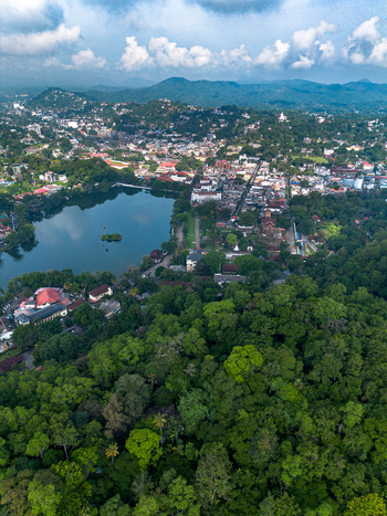 Aerial view of Kandy Lake surrounded by lush tropical forests and the historic city buildings of Kandy Central Province Sri Lanka. Aerial view of Kandy Lake surrounded by lush tropical forests and the historic city buildings of Kandy Central Province Sri Lanka.