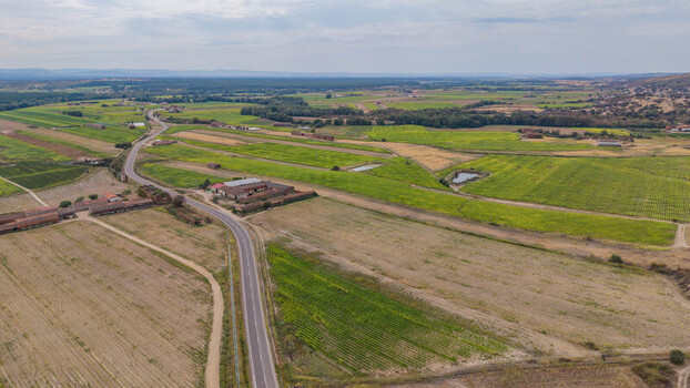 Aerial view of the rural landscape near Talayuela featuring agricultural fields a winding road and farm buildings in Talayuela Extremadura Spain. Aerial view of the rural landscape near Talayuela featuring agricultural fields a winding road and farm buildings in Talayuela Extremadura Spain.