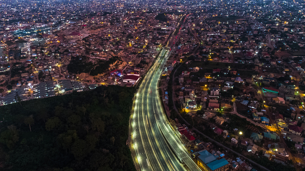 Aerial view of the illuminated Pokuase Interchange at night featuring multi level road networks urban sprawl and glowing streetlights in Ga North Municipal Greater Accra Region Ghana. Aerial view of the illuminated Pokuase Interchange at night featuring multi level road networks urban sprawl and glowing streetlights in Ga North Municipal Greater Accra Region Ghana.