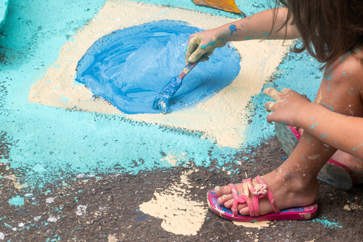 Rio de Janeiro Brazil 13 June 2026 View of a child painting a blue circle on the asphalt street with a brush preparing decorations for the World Cup 2026.