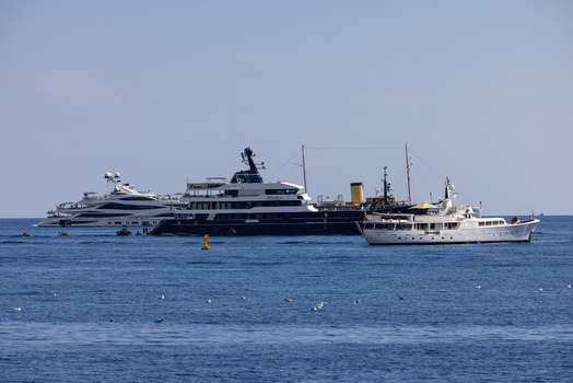 Aerial view of luxury yachts anchored in the blue waters off the coast of Monaco City Monaco.