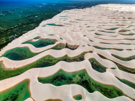 Aerial view of Lagoa Bonita featuring white sand dunes and vibrant turquoise rainwater lagoons amidst lush vegetation Barreirinhas Maranhao Brazil. Aerial view of Lagoa Bonita featuring white sand dunes and vibrant turquoise rainwater lagoons amidst lush vegetation Barreirinhas Maranhao Brazil.