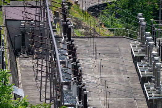 Aerial view of the electrical substation infrastructure with high voltage insulators and power lines near the Verzasca Dam in Gordola Ticino Switzerland. Aerial view of the electrical substation infrastructure with high voltage insulators and power lines near the Verzasca Dam in Gordola Ticino Switzerland.
