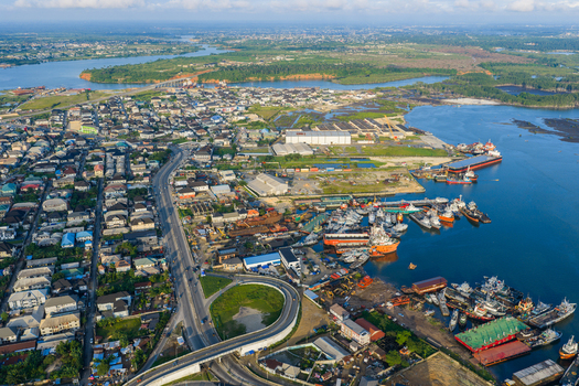 Port Harcourt Nigeria 03 July 2026 Aerial view of the port area with docked ships industrial warehouses and a highway interchange winding through the urban landscape. Port Harcourt Nigeria 03 July 2026 Aerial view of the port area with docked ships industrial warehouses and a highway interchange winding through the urban landscape.