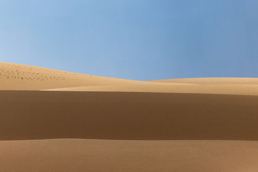 View of golden sand dunes under a clear blue sky in Da ira Socotra Yemen.
