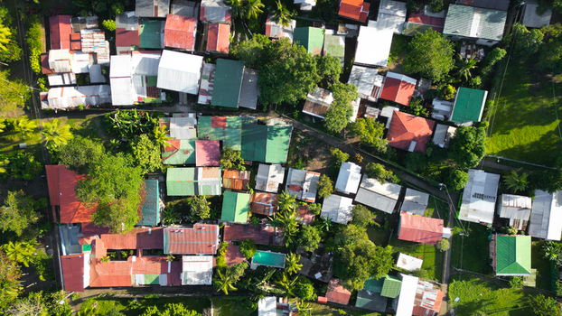 Aerial view of a vibrant tapestry of colorful rooftops nestled among lush green trees a peaceful community thriving in nature s embrace Tortuguero Limón Province Costa Rica. Aerial view of a vibrant tapestry of colorful rooftops nestled among lush green trees a peaceful community thriving in nature s embrace Tortuguero Limón Province Costa Rica.