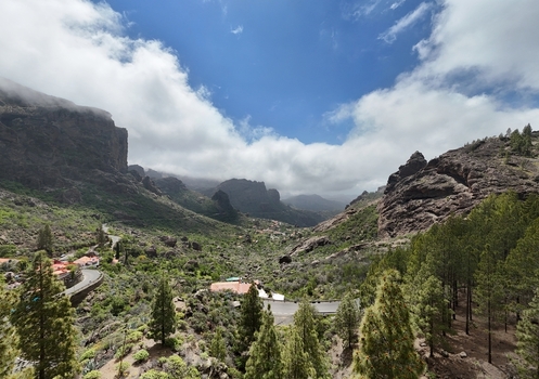 Aerial view of a lush valley nestled between rugged cliffs under a vast sky Caminito Roque Nublo La Culata Canarias Spain. Aerial view of a lush valley nestled between rugged cliffs under a vast sky Caminito Roque Nublo La Culata Canarias Spain.