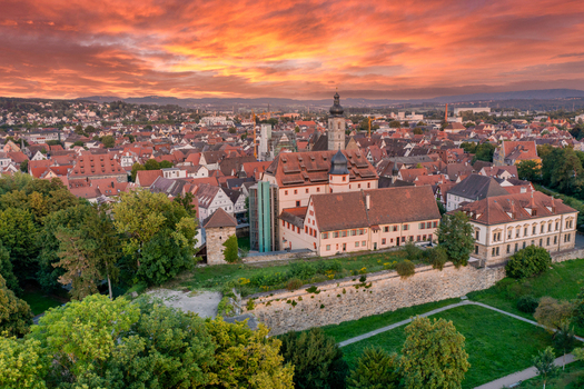 Aerial view of Forchheim Castle and the historic old town with red tiled roofs under a vibrant sunset sky Forchheim Bayern Germany.