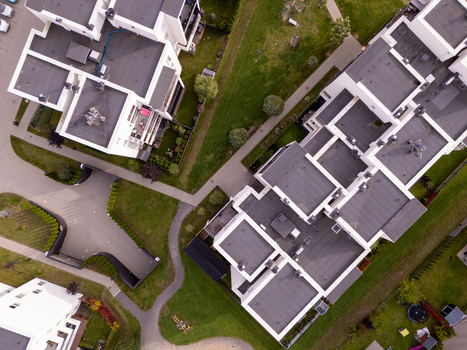 Aerial view of modern residential apartment buildings with flat roofs surrounded by green lawns and pedestrian pathways in Gdansk Poland. Aerial view of modern residential apartment buildings with flat roofs surrounded by green lawns and pedestrian pathways in Gdansk Poland.