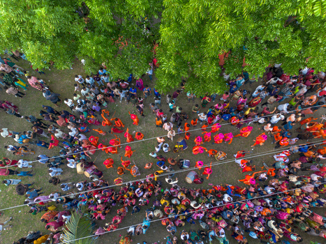 Munshiganj Bangladesh 13 April 2026 Aerial view of a vibrant gathering where colorful attires pop against the muted ground shadowed by the lush green canopy above.