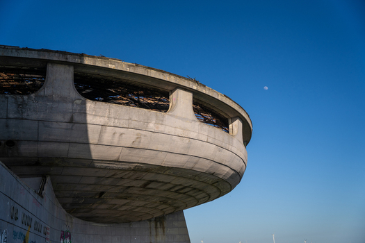 View of the Buzludzha Monument a striking example of brutalist architecture with its iconic circular concrete structure set against a clear blue sky in Stara Zagora Bulgaria. View of the Buzludzha Monument a striking example of brutalist architecture with its iconic circular concrete structure set against a clear blue sky in Stara Zagora Bulgaria.